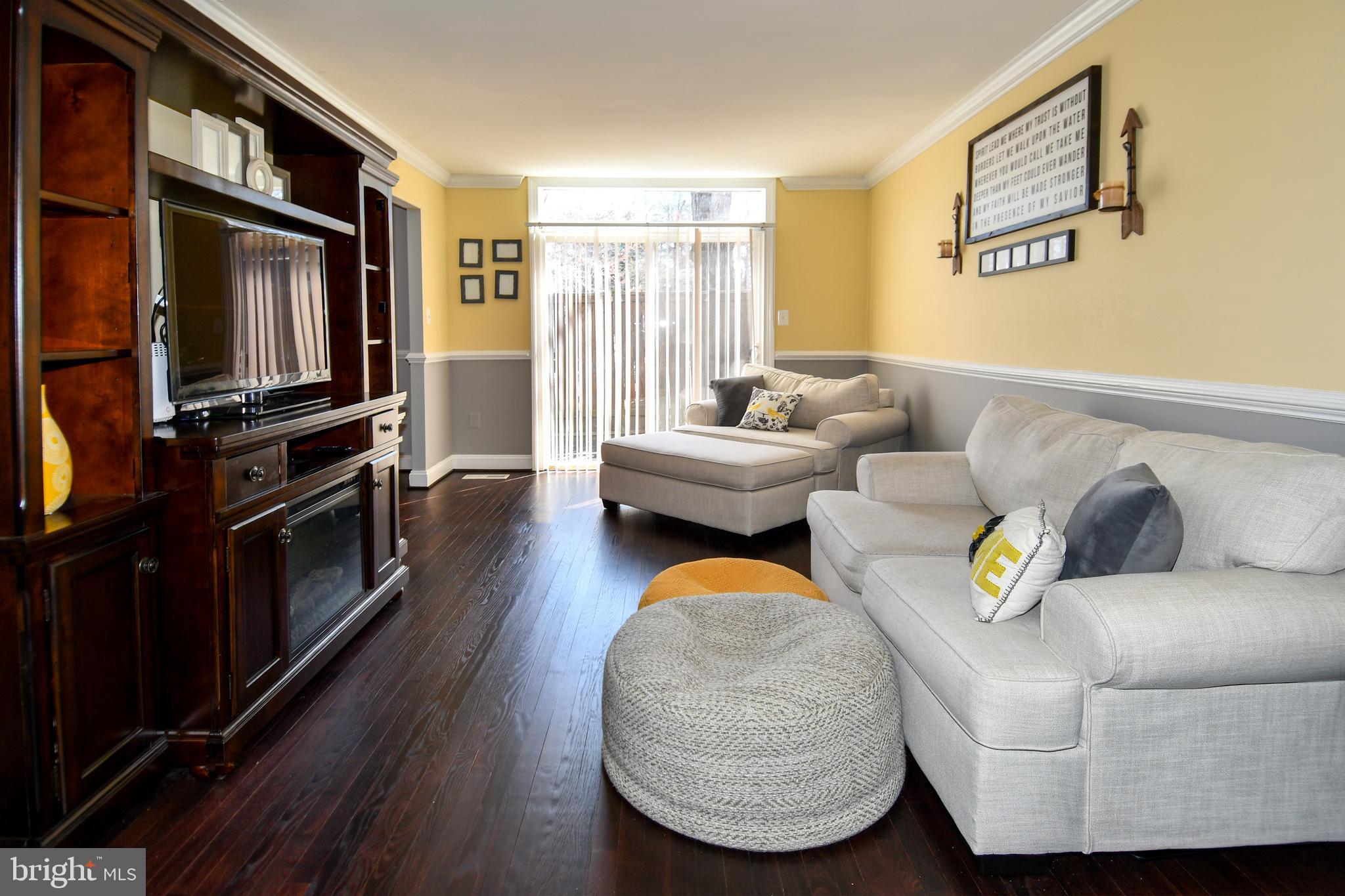 12604 Dulcinea Place Woodbridge, VA 22192 - Photo 13 of 63 a living room with furniture and a flat screen tv