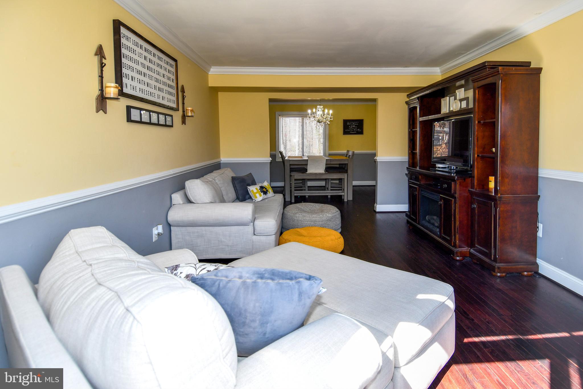 12604 Dulcinea Place Woodbridge, VA 22192 - Photo 16 of 63 a living room with furniture flat screen tv and a window