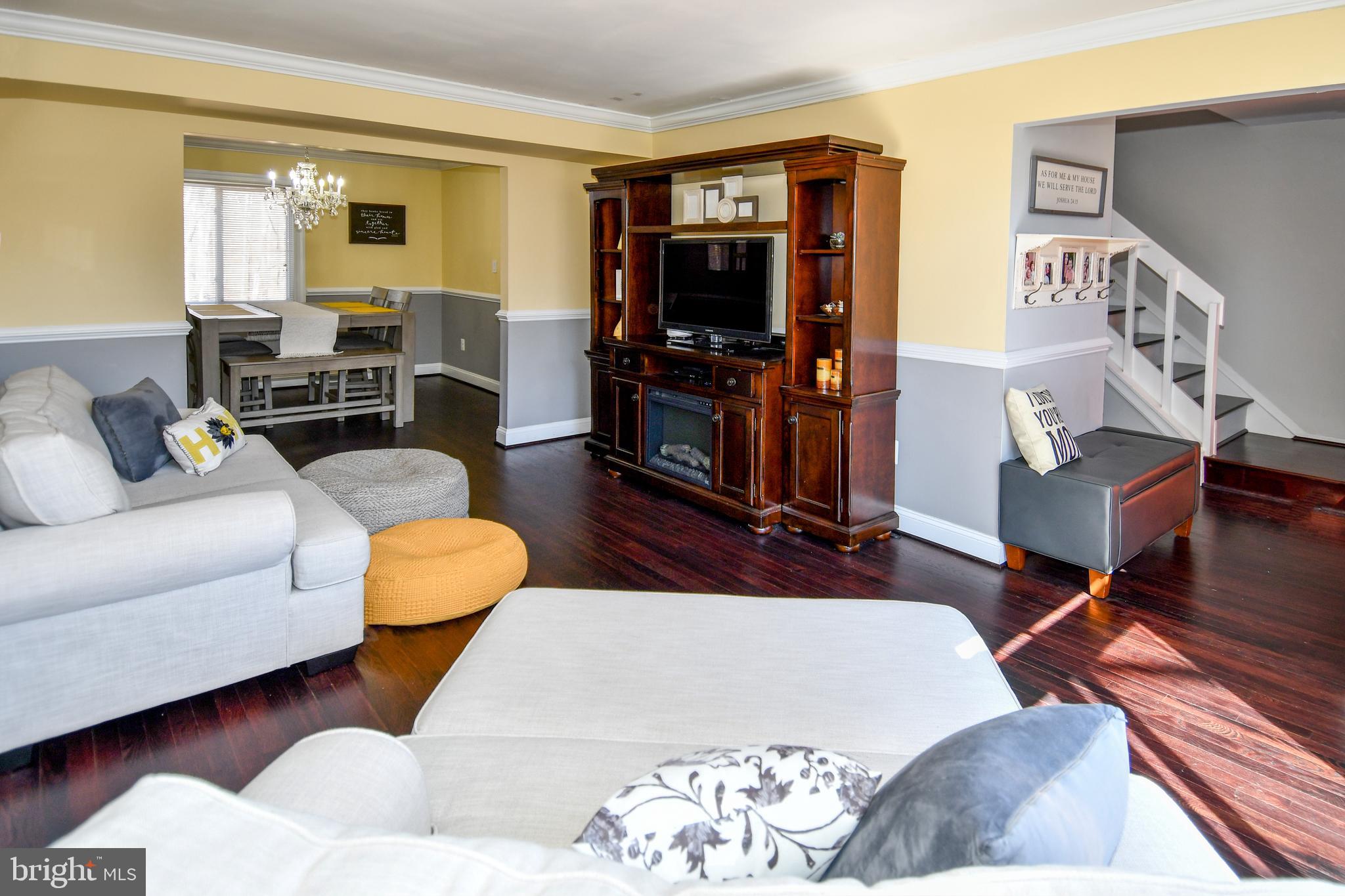 12604 Dulcinea Place Woodbridge, VA 22192 - Photo 17 of 63 a living room with furniture and a flat screen tv