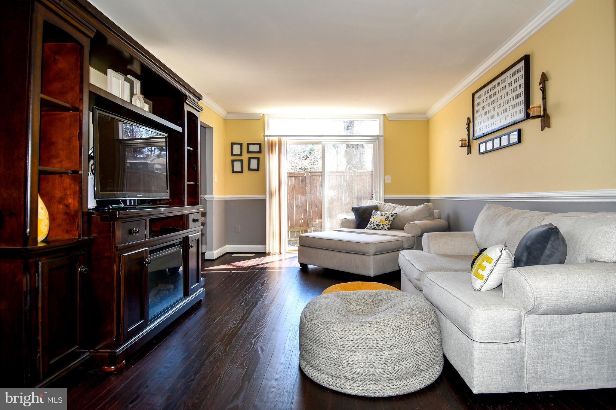 12604 Dulcinea Place Woodbridge, VA 22192 - Photo 18 of 63 a living room with furniture and a flat screen tv