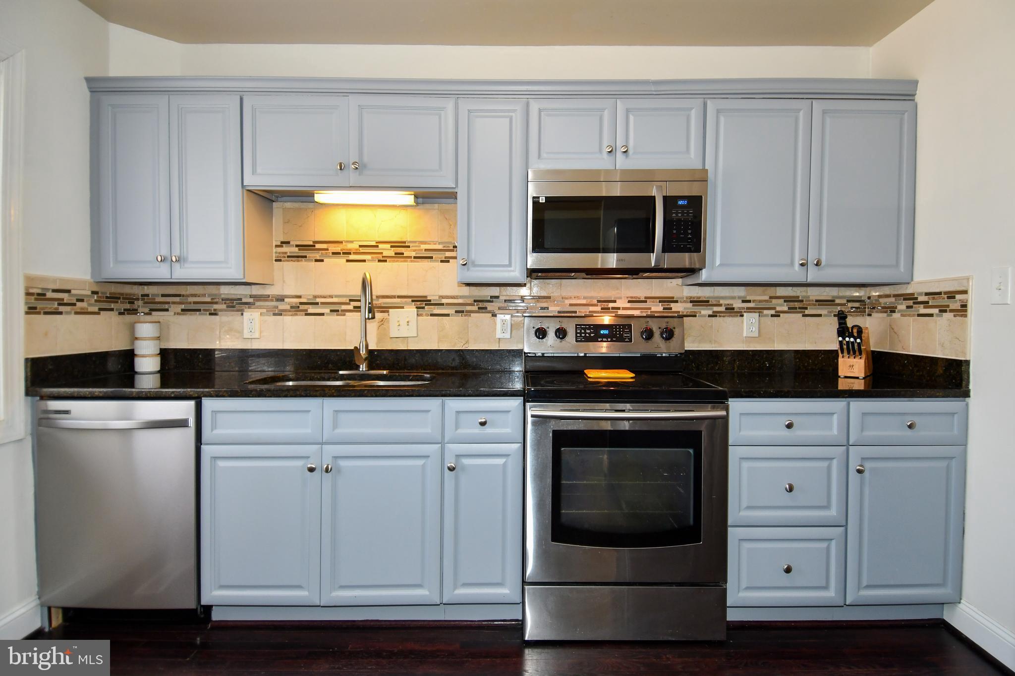 12604 Dulcinea Place Woodbridge, VA 22192 - Photo 22 of 63 a kitchen with stainless steel appliances granite countertop a sink stove and microwave