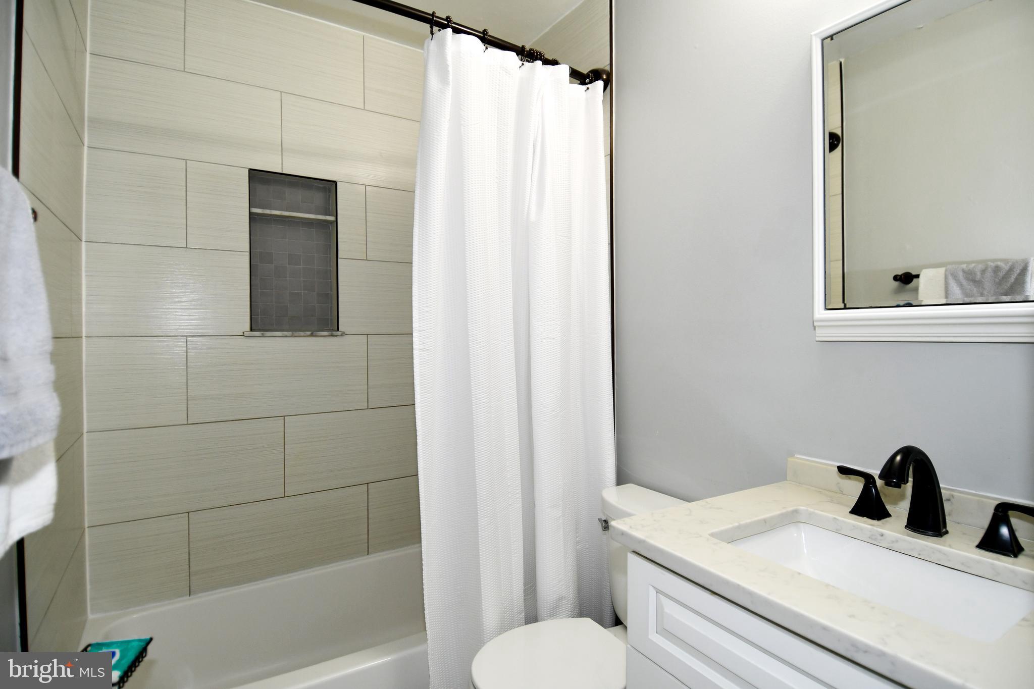 12604 Dulcinea Place Woodbridge, VA 22192 - Photo 32 of 63 a bathroom with a sink toilet and shower