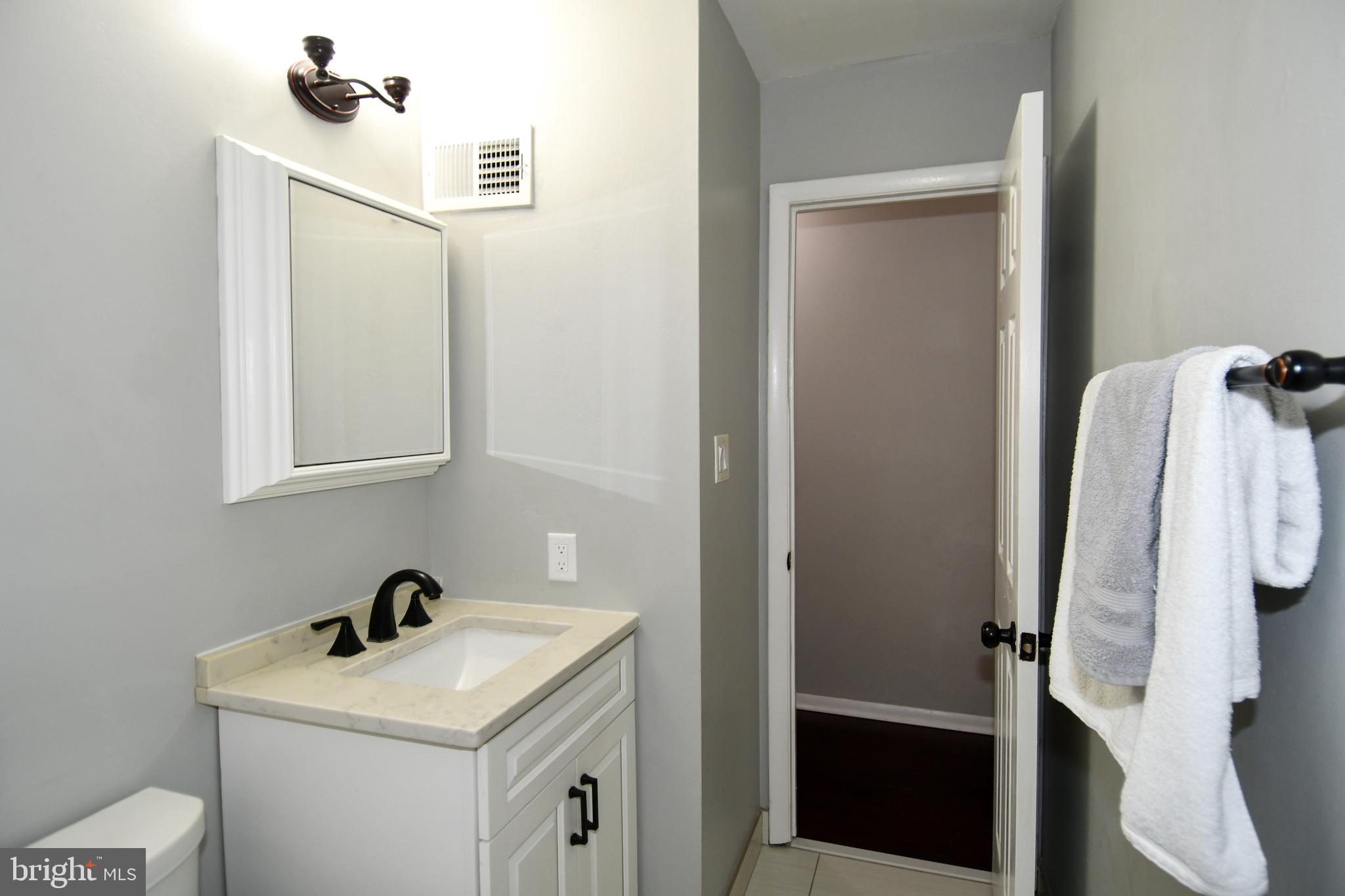 12604 Dulcinea Place Woodbridge, VA 22192 - Photo 33 of 63 a bathroom with a sink vanity and toilet