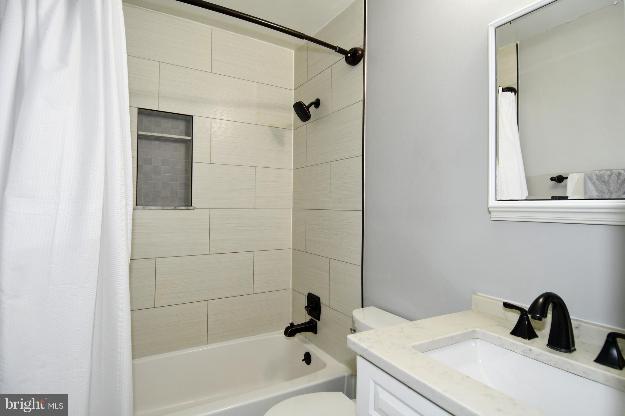 12604 Dulcinea Place Woodbridge, VA 22192 - Photo 34 of 63 a bathroom with a sink toilet and shower