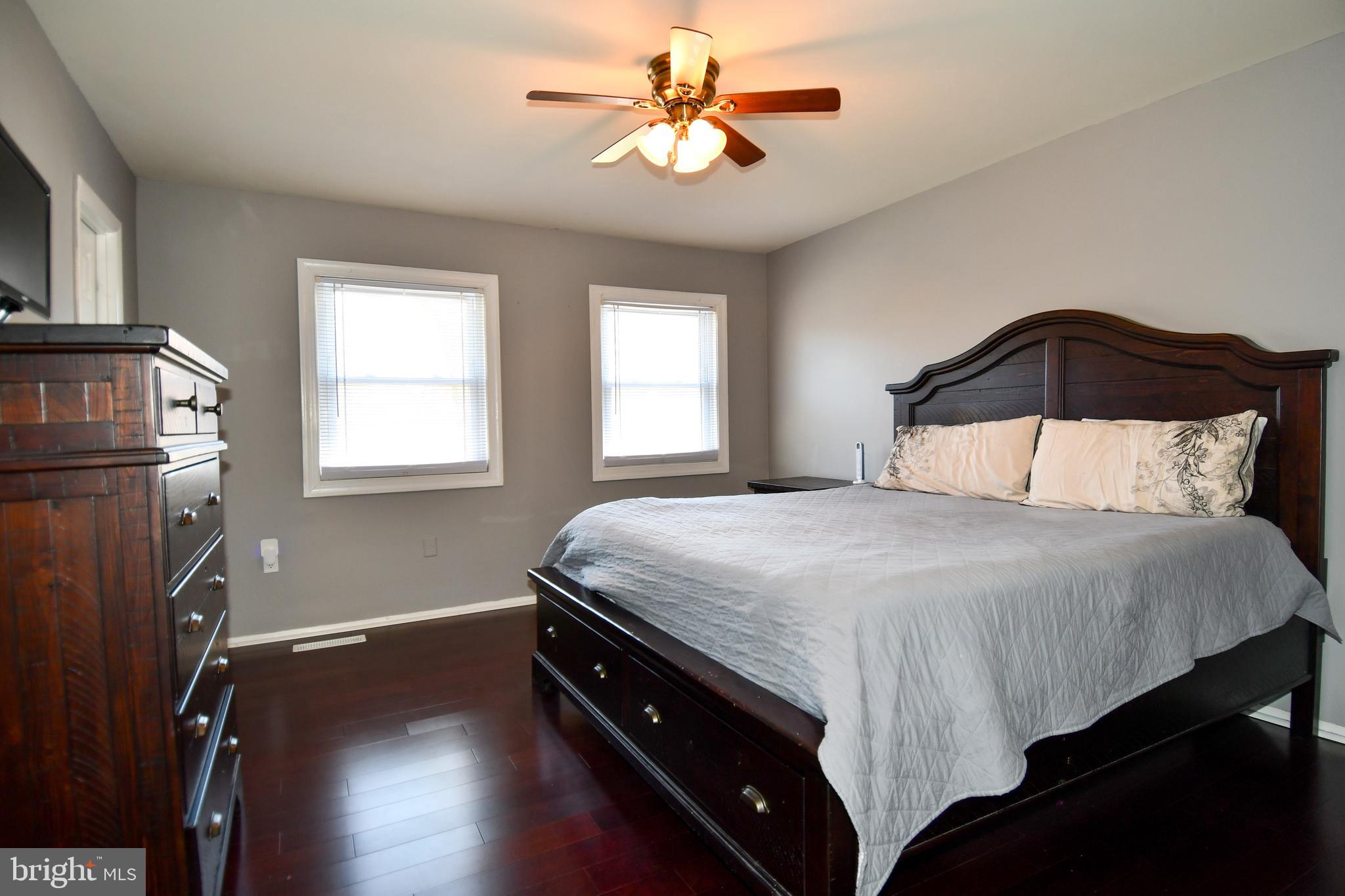 12604 Dulcinea Place Woodbridge, VA 22192 - Photo 35 of 63 a bedroom with a bed and a chandelier