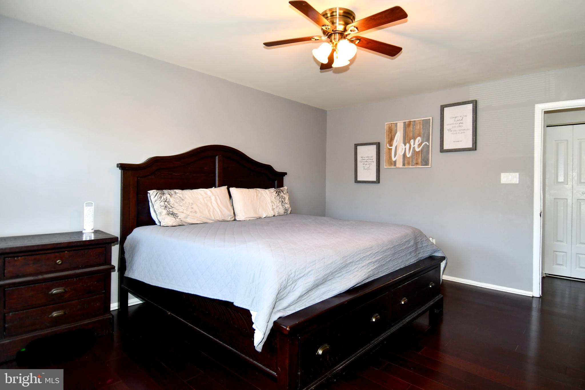 12604 Dulcinea Place Woodbridge, VA 22192 - Photo 36 of 63 a bedroom with a bed and a chandelier