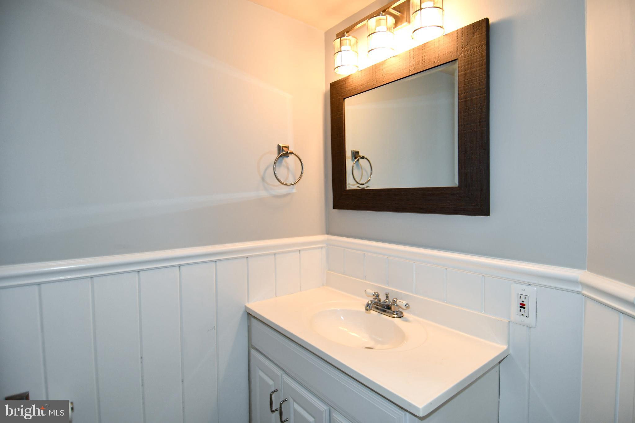 12604 Dulcinea Place Woodbridge, VA 22192 - Photo 45 of 63 a bathroom with a sink vanity and mirror