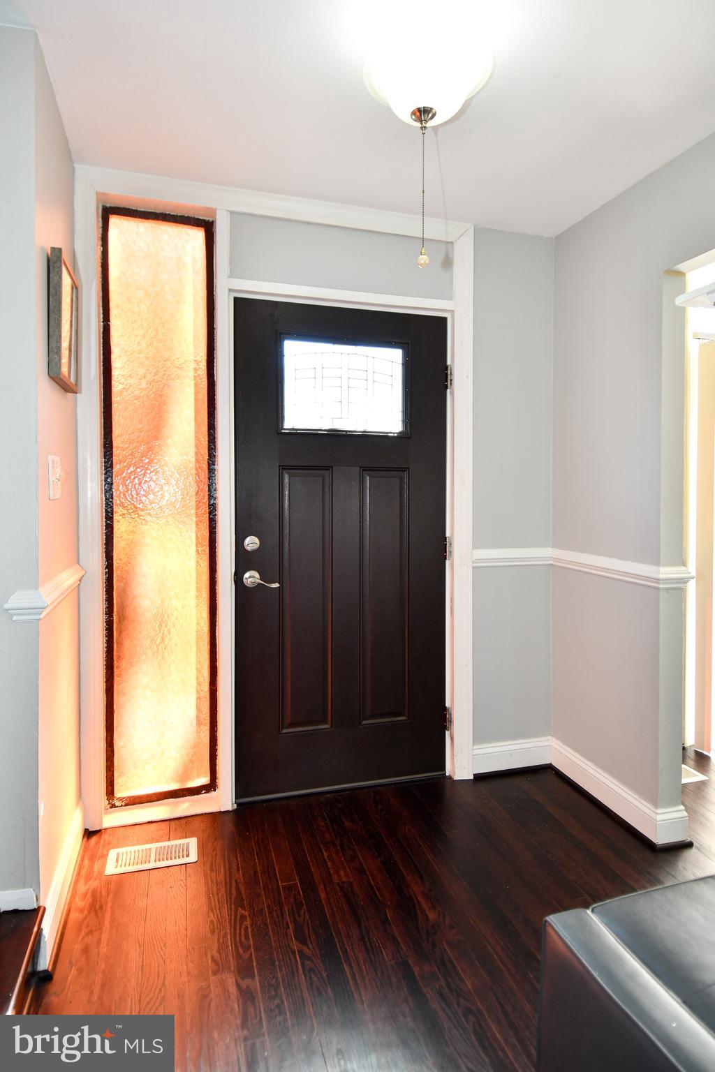 12604 Dulcinea Place Woodbridge, VA 22192 - Photo 6 of 63 a view of an empty room with wooden floor and a window