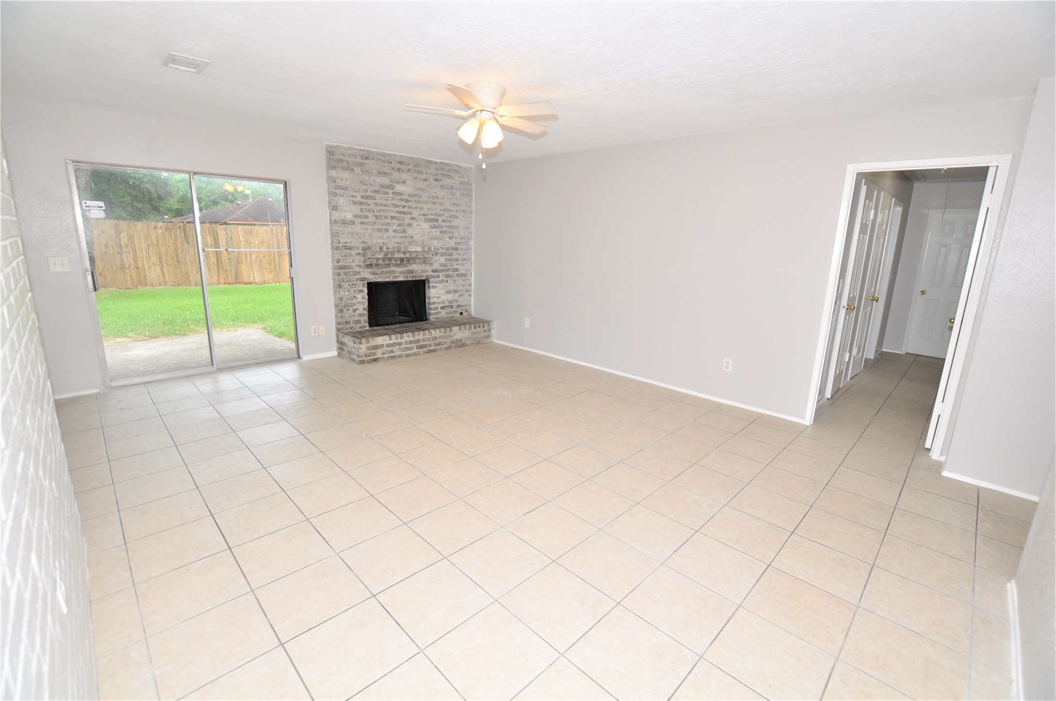 5446 Quail Tree Lane Humble, TX 77346 - Photo 4 of 12 a view of an empty room with a fireplace