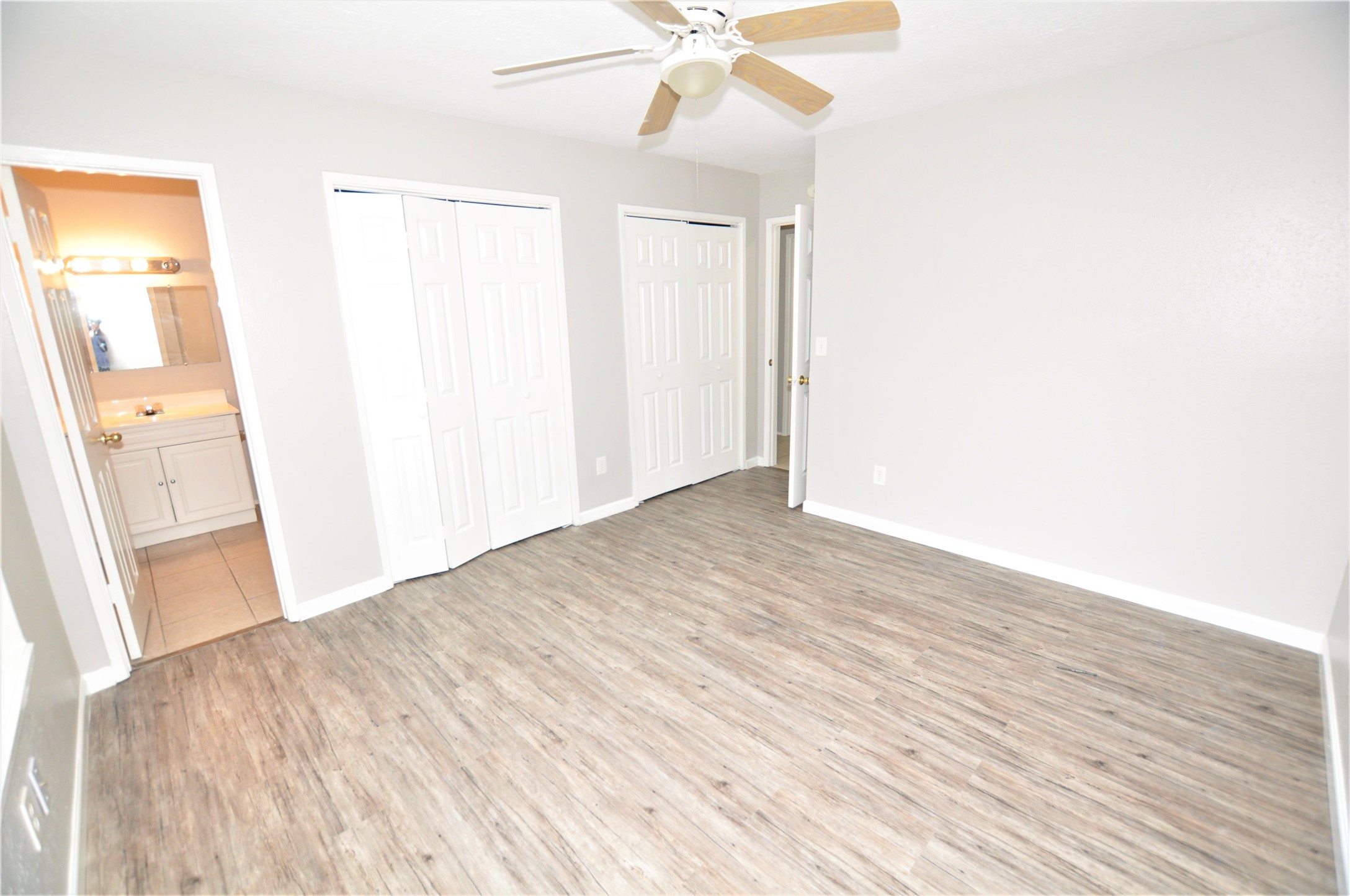 5446 Quail Tree Lane Humble, TX 77346 - Photo 7 of 12 a view of a big room with wooden floor and a chandelier fan