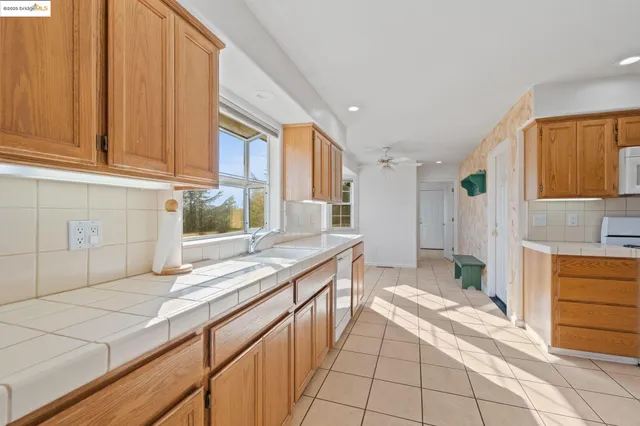 a kitchen with stainless steel appliances granite countertop a sink and cabinets