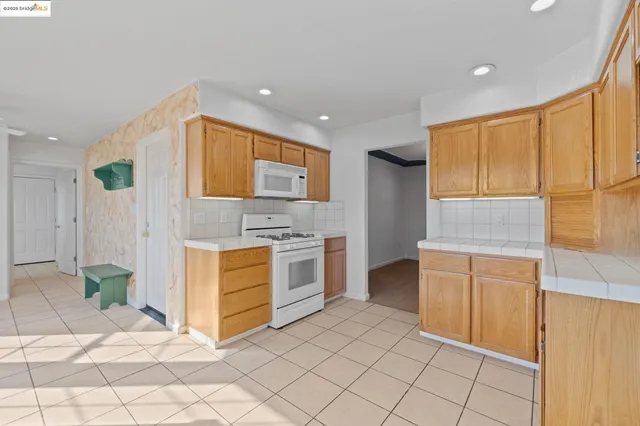 a kitchen with stainless steel appliances a stove a sink and a refrigerator