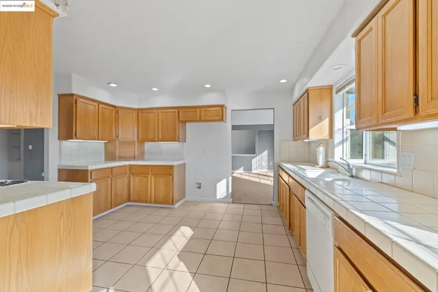 a kitchen with stainless steel appliances granite countertop a sink and cabinets