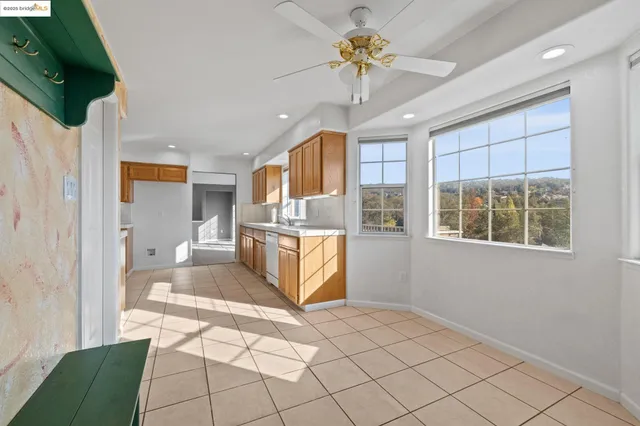 a view of a kitchen with furniture and a ceiling fan
