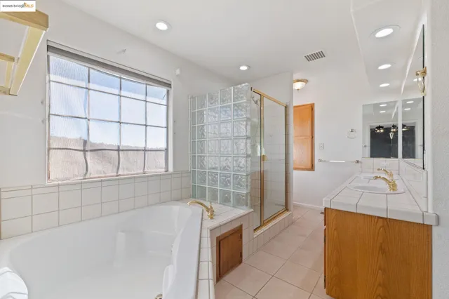 a bathroom with a tub shower and sink