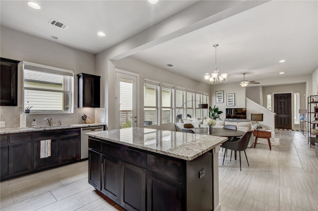 a large kitchen with lots of counter space and sink