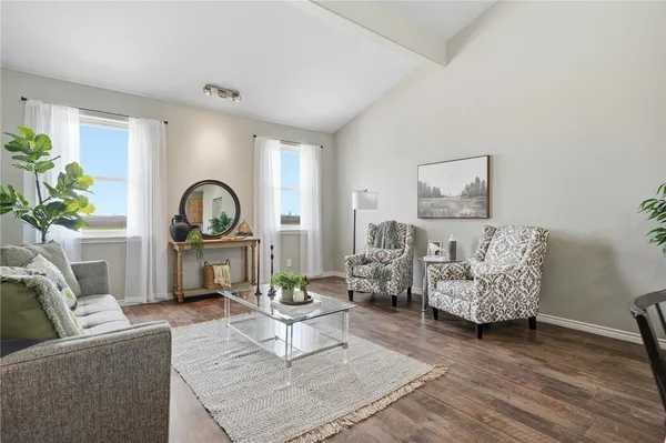 a living room with furniture and a potted plant