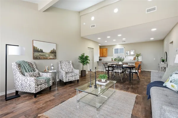 a living room with furniture and wooden floor