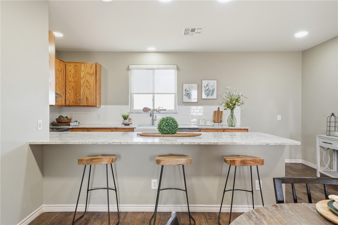4642 Lackey Taft, TX 78390 - Photo 13 of 40 a kitchen with stainless steel appliances a white table chairs and a window