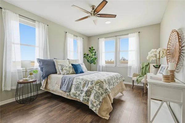 a bedroom with a bed a couch and a window