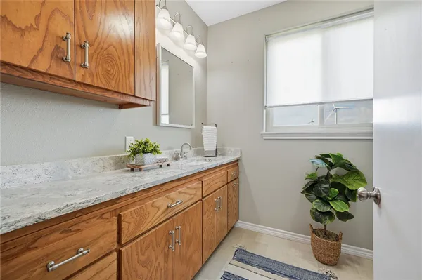 a bathroom with a sink a vanity and a window