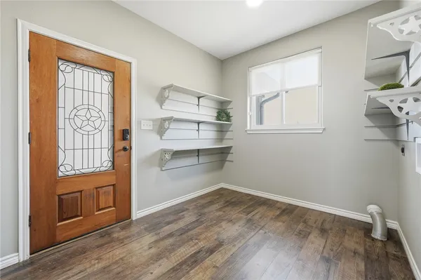 a room with a hardwood floor and a window
