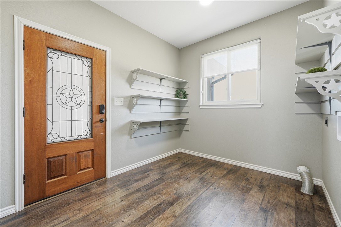 4642 Lackey Taft, TX 78390 - Photo 23 of 40 a room with a hardwood floor and a window