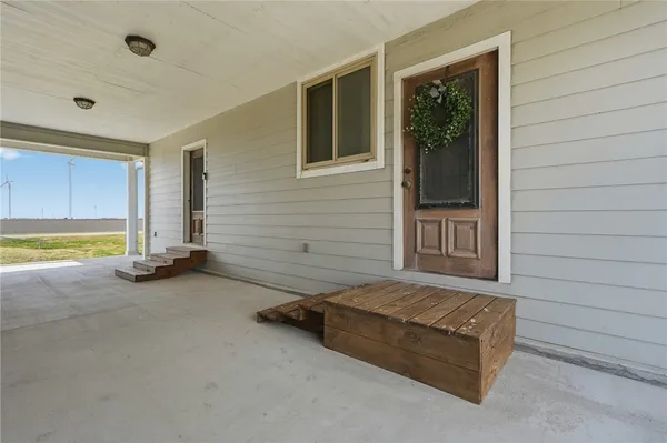 a view of an empty room and a window