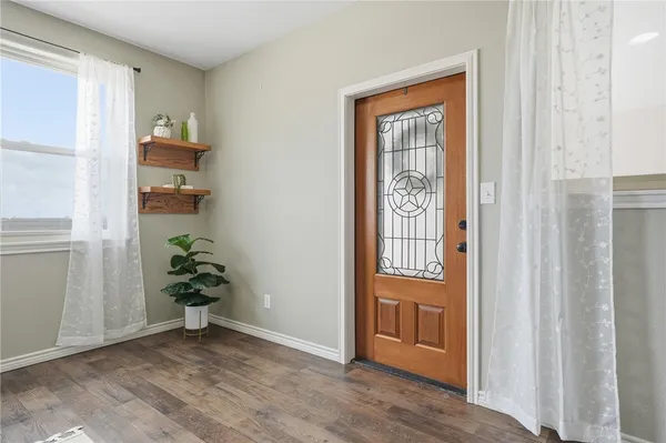 a view of an entryway with wooden floor