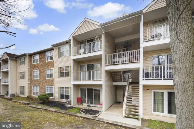 a front view of a residential apartment building with a yard