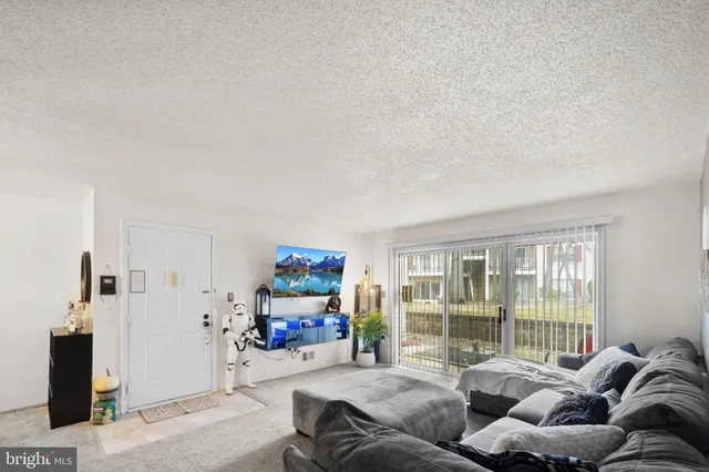 a living room with furniture and a floor to ceiling window