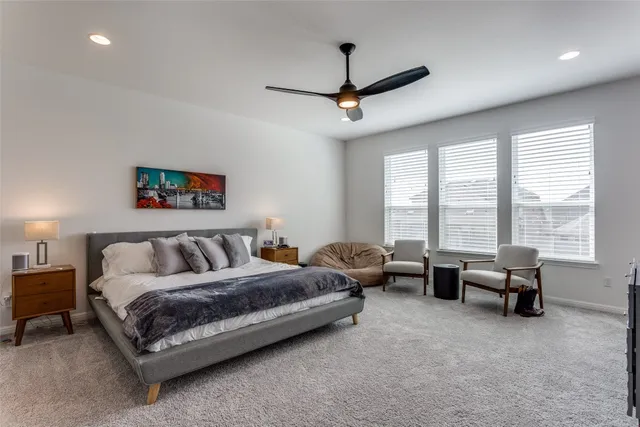 a spacious bedroom with a bed and a couch