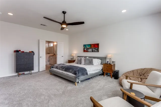 a spacious bedroom with a bed and furniture