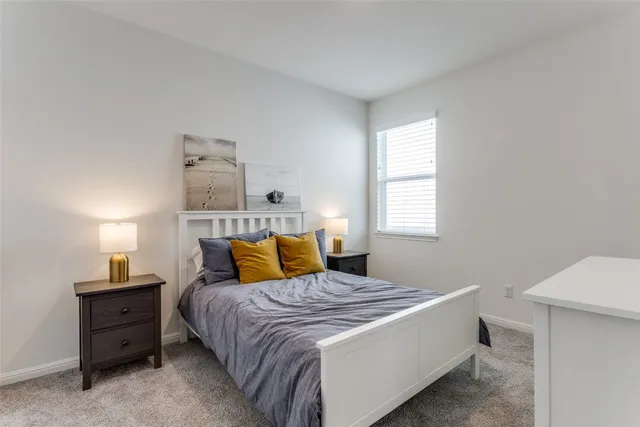 a bedroom with a bed and window