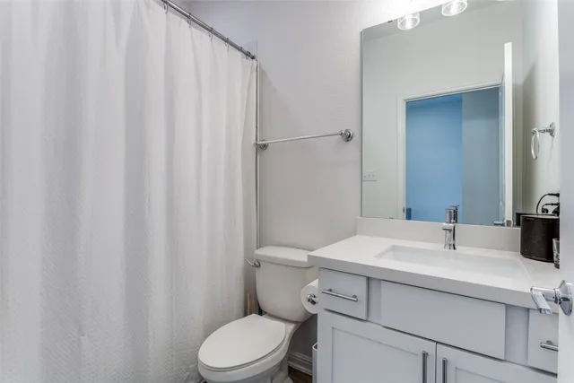 a bathroom with a sink toilet and vanity