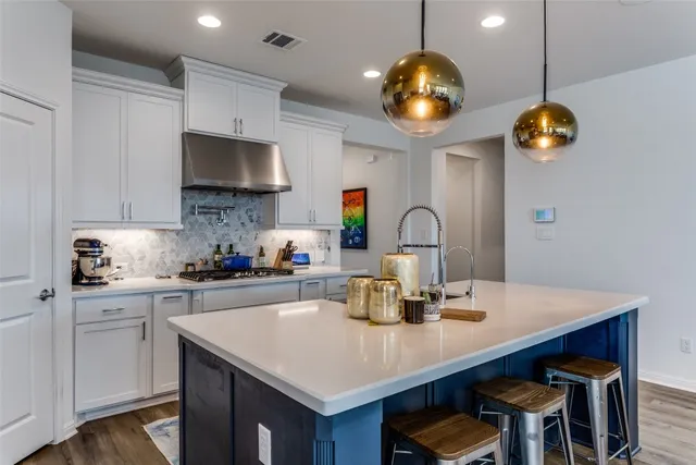 a kitchen with a counter space a sink and cabinets