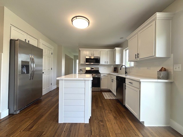 508 Ramsden Road Plano, IL 60545 - Photo 9 of 20 a kitchen with granite countertop wooden floors stainless steel appliances a sink and a window
