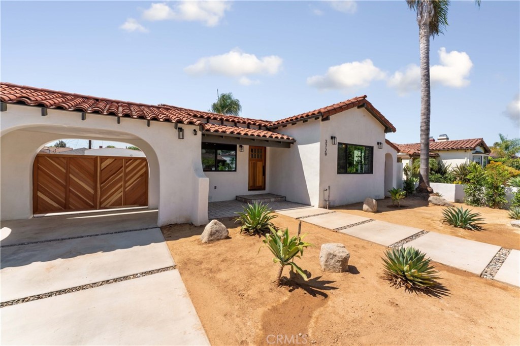 3729 Buckingham Road Los Angeles, CA 90016 - Photo 1 of 1 a front view of a house with a garden
