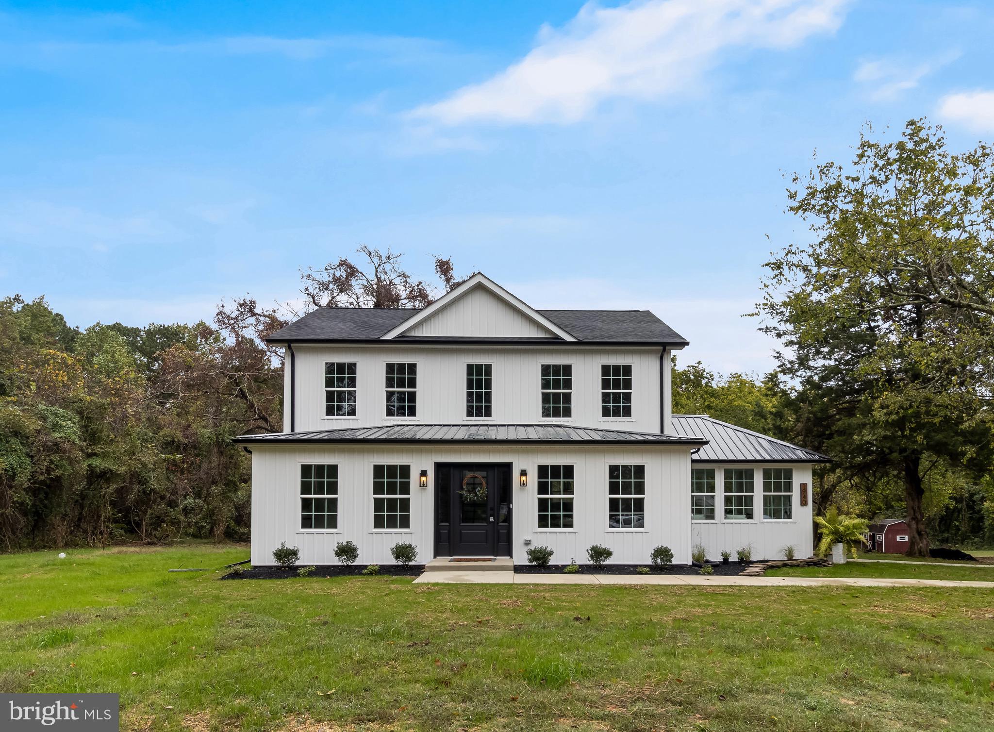 1940 Adelina Road Prince Frederick, MD 20678 - Photo 1 of 37 a front view of a house with a garden and trees
