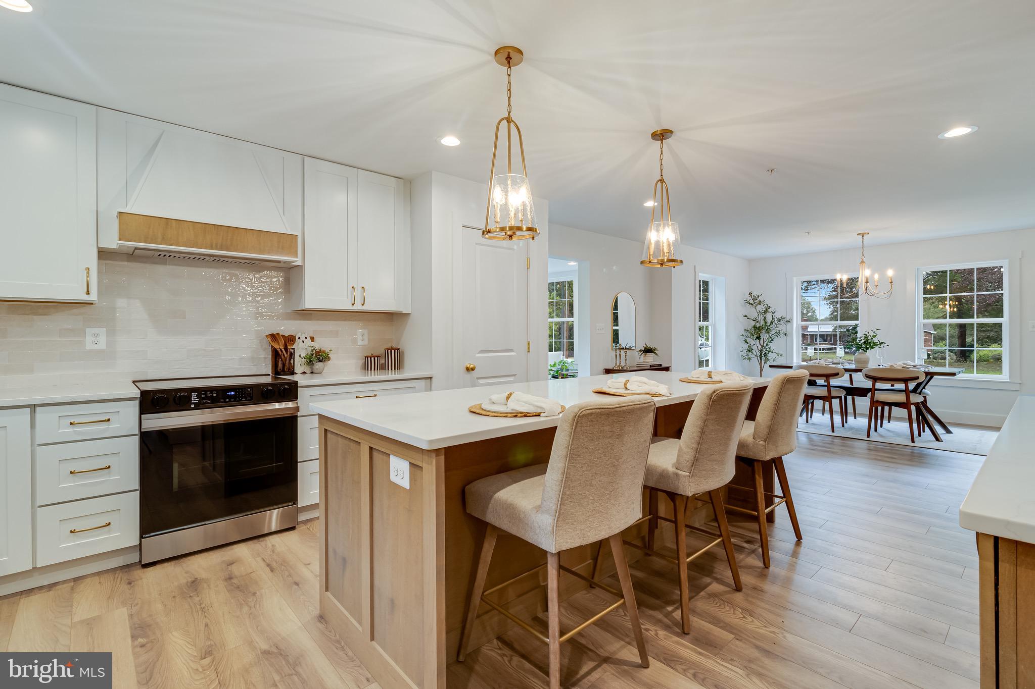 1940 Adelina Road Prince Frederick, MD 20678 - Photo 13 of 37 a kitchen with a dining table chairs stainless steel appliances and cabinets