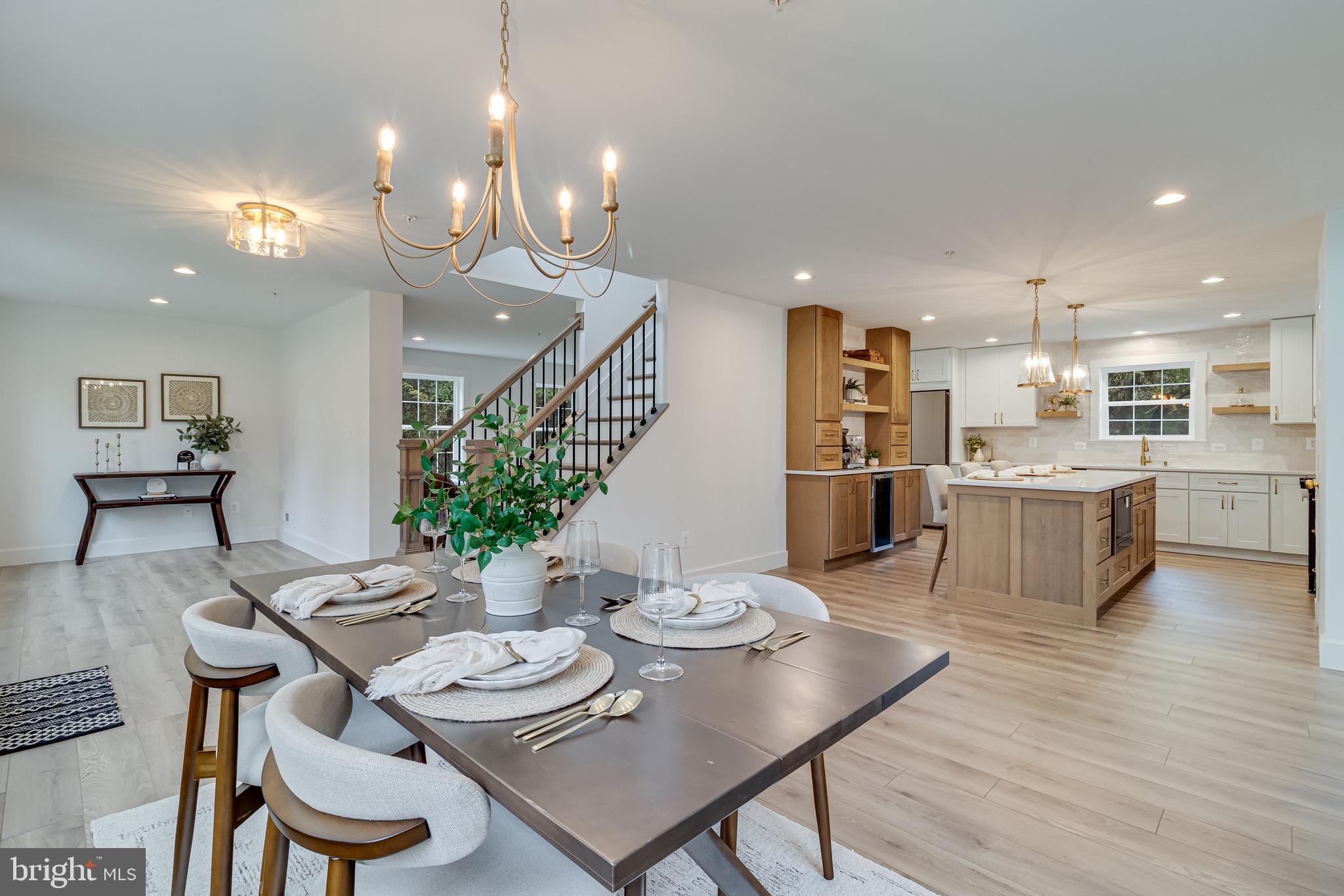1940 Adelina Road Prince Frederick, MD 20678 - Photo 18 of 37 a view of a dining room and livingroom with furniture wooden floor a chandelier