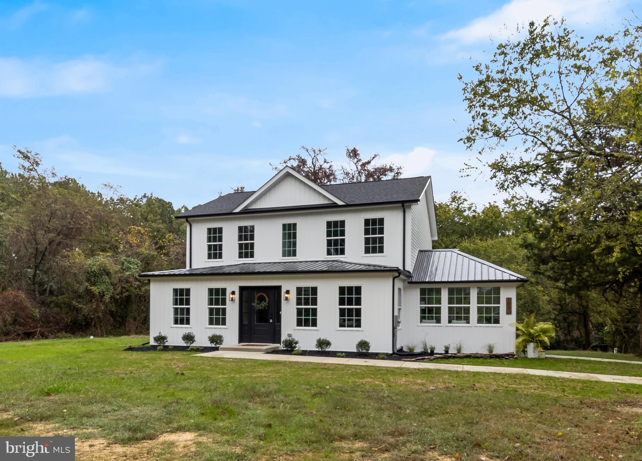 1940 Adelina Road Prince Frederick, MD 20678 - Photo 2 of 37 a front view of a house with a garden