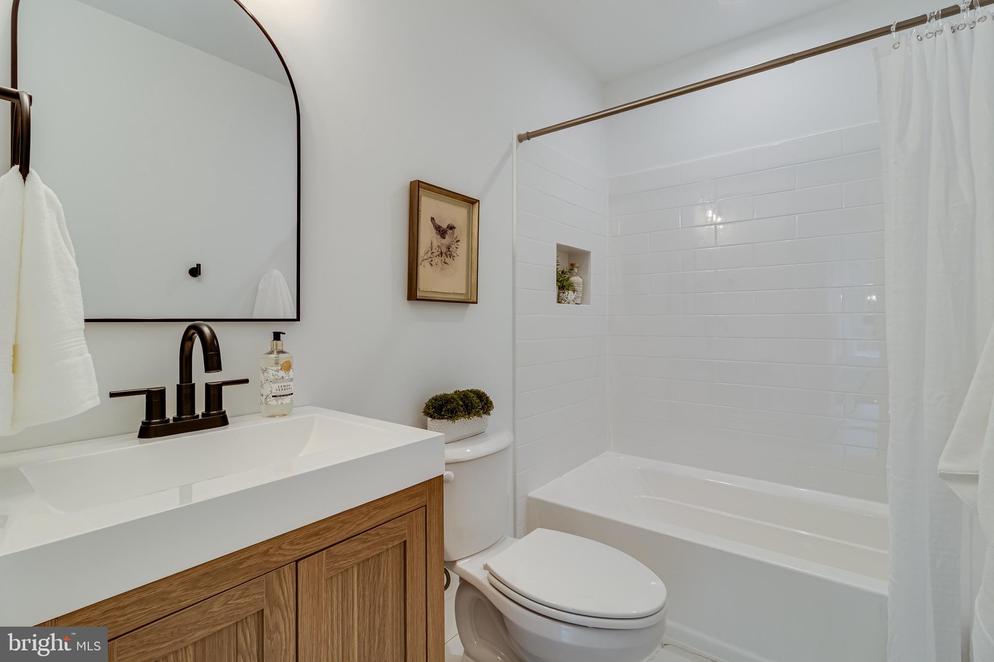 1940 Adelina Road Prince Frederick, MD 20678 - Photo 22 of 37 a bathroom with a sink a toilet and shower