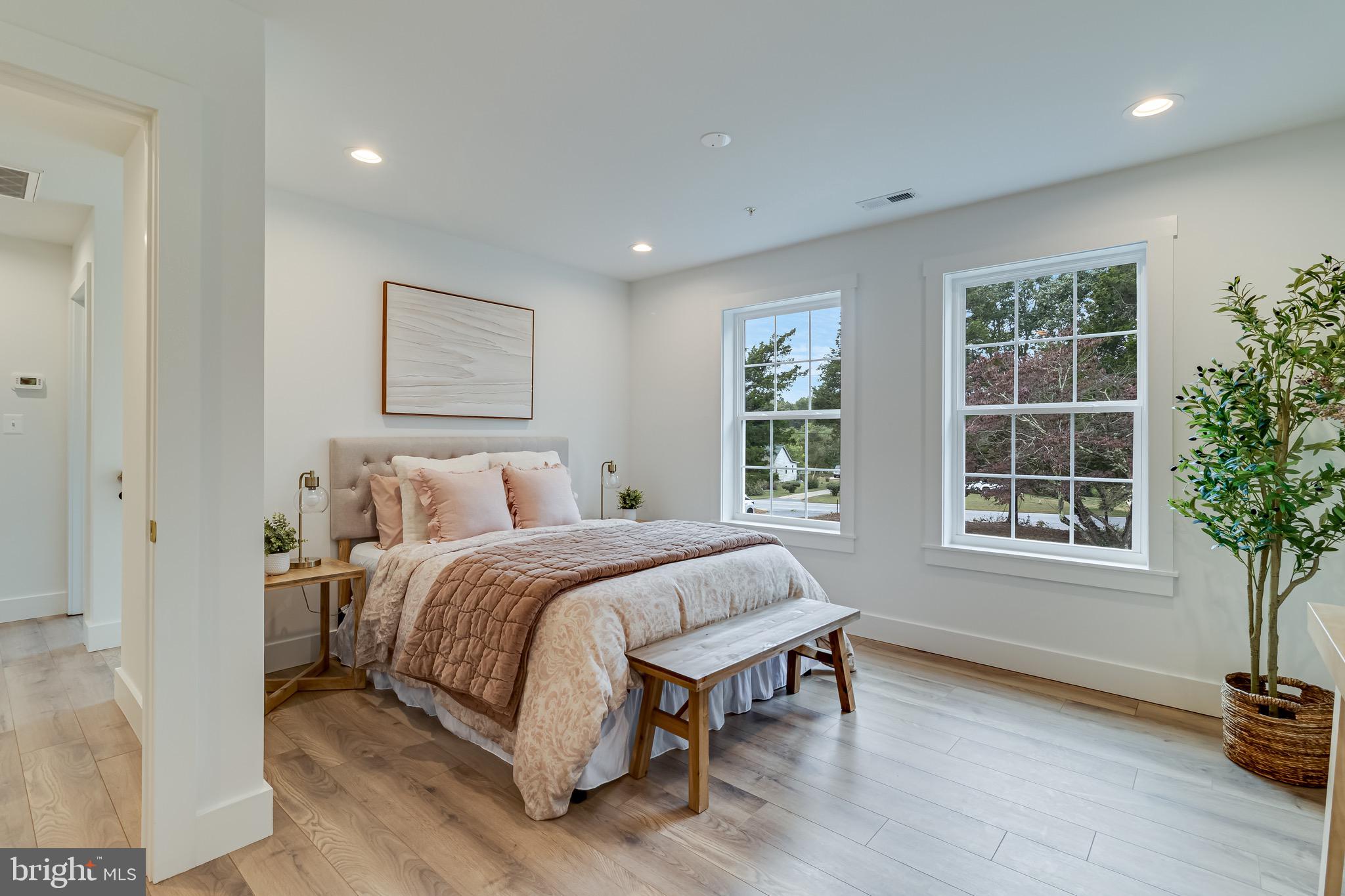 1940 Adelina Road Prince Frederick, MD 20678 - Photo 25 of 37 a spacious bedroom with a bed a table and a window