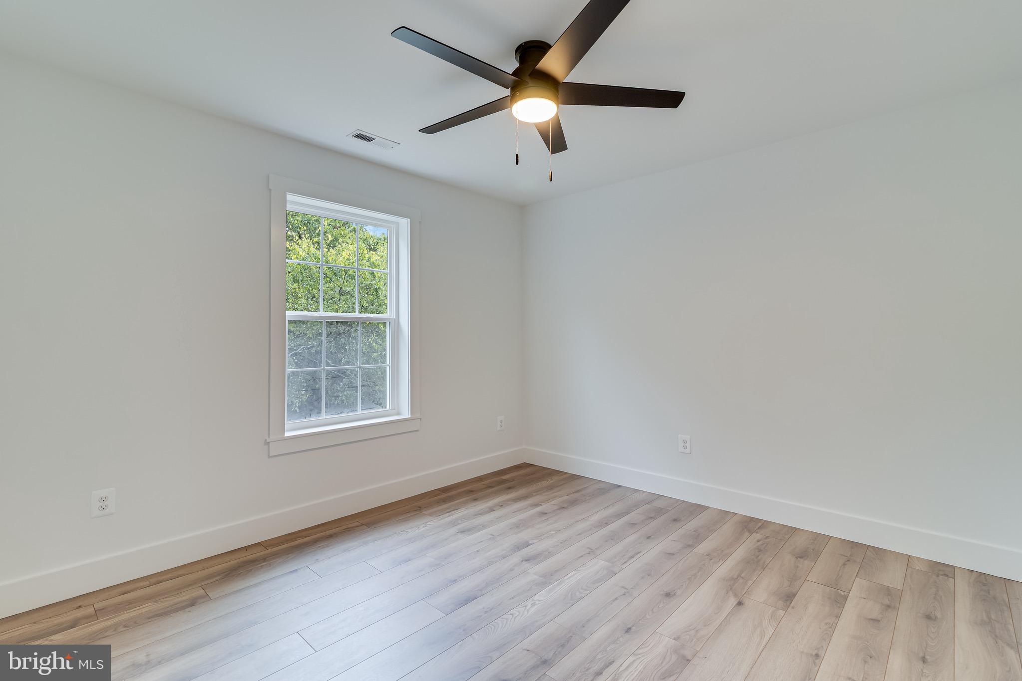 1940 Adelina Road Prince Frederick, MD 20678 - Photo 27 of 37 an empty room with wooden floor and windows
