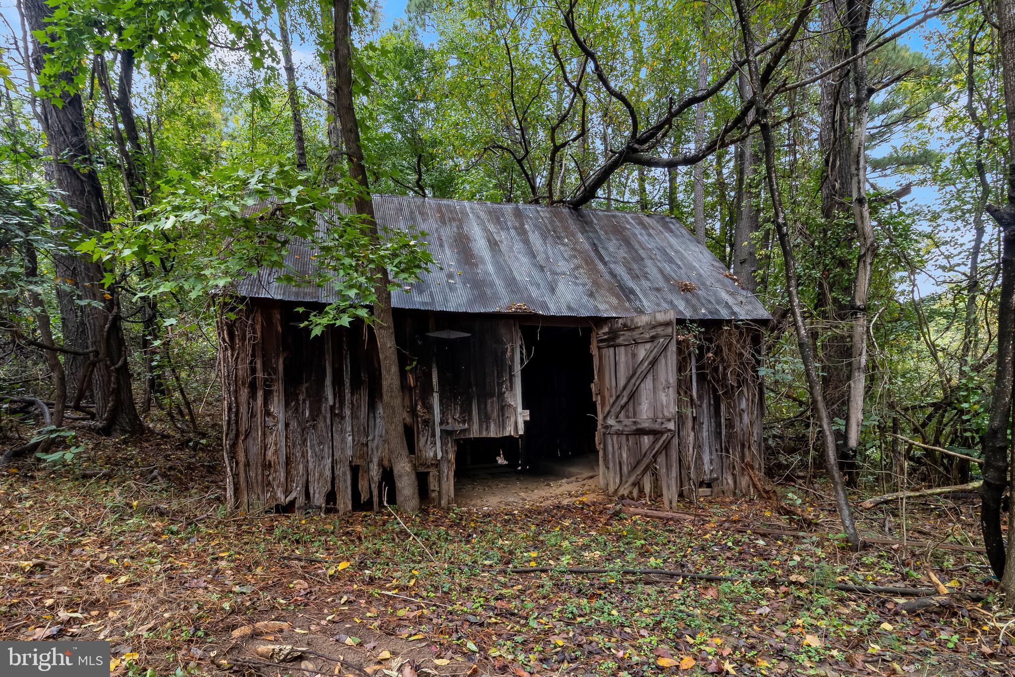 1940 Adelina Road Prince Frederick, MD 20678 - Photo 30 of 37 a view of a barn with wooden fence and large trees