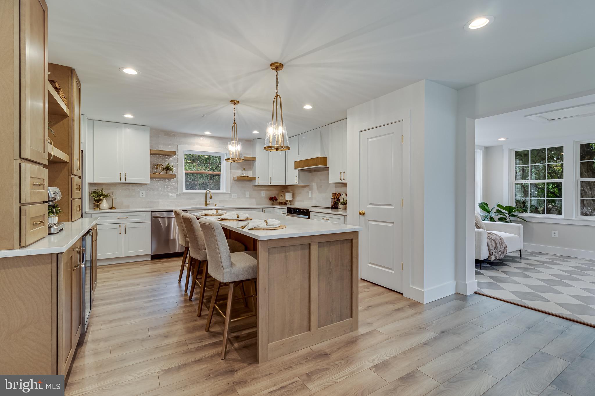 1940 Adelina Road Prince Frederick, MD 20678 - Photo 9 of 37 a kitchen with kitchen island granite countertop a sink cabinets and wooden floor