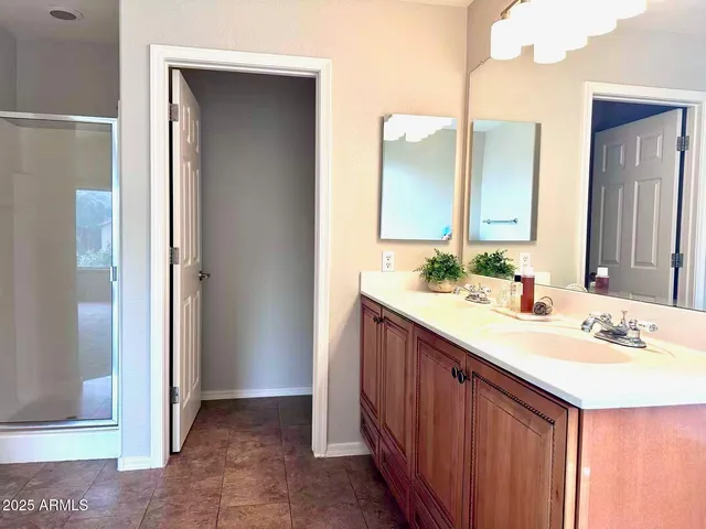 an empty room with windows and ceiling fan