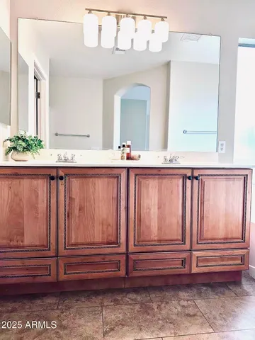 a bathroom with a double vanity sink and mirror