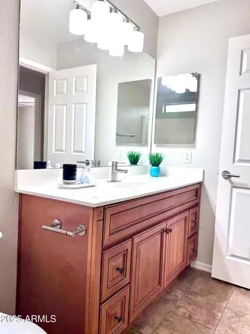 an empty room with a window and ceiling fan